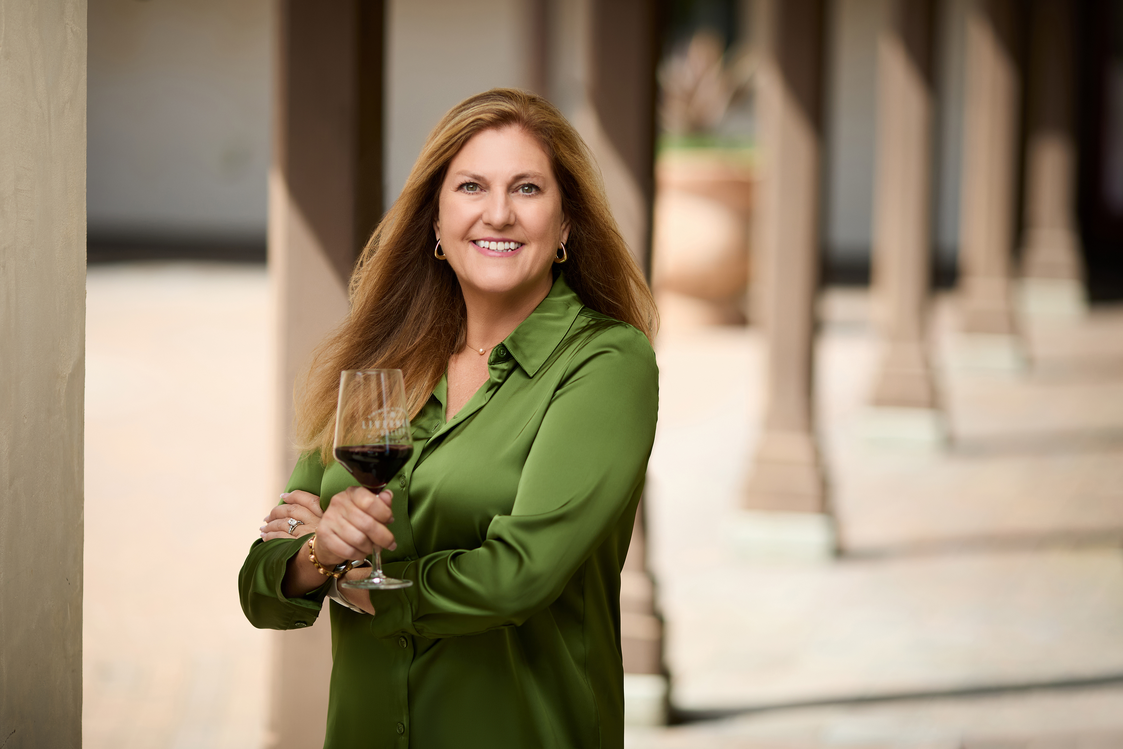 Lisa Tolido holding a glass of red wine