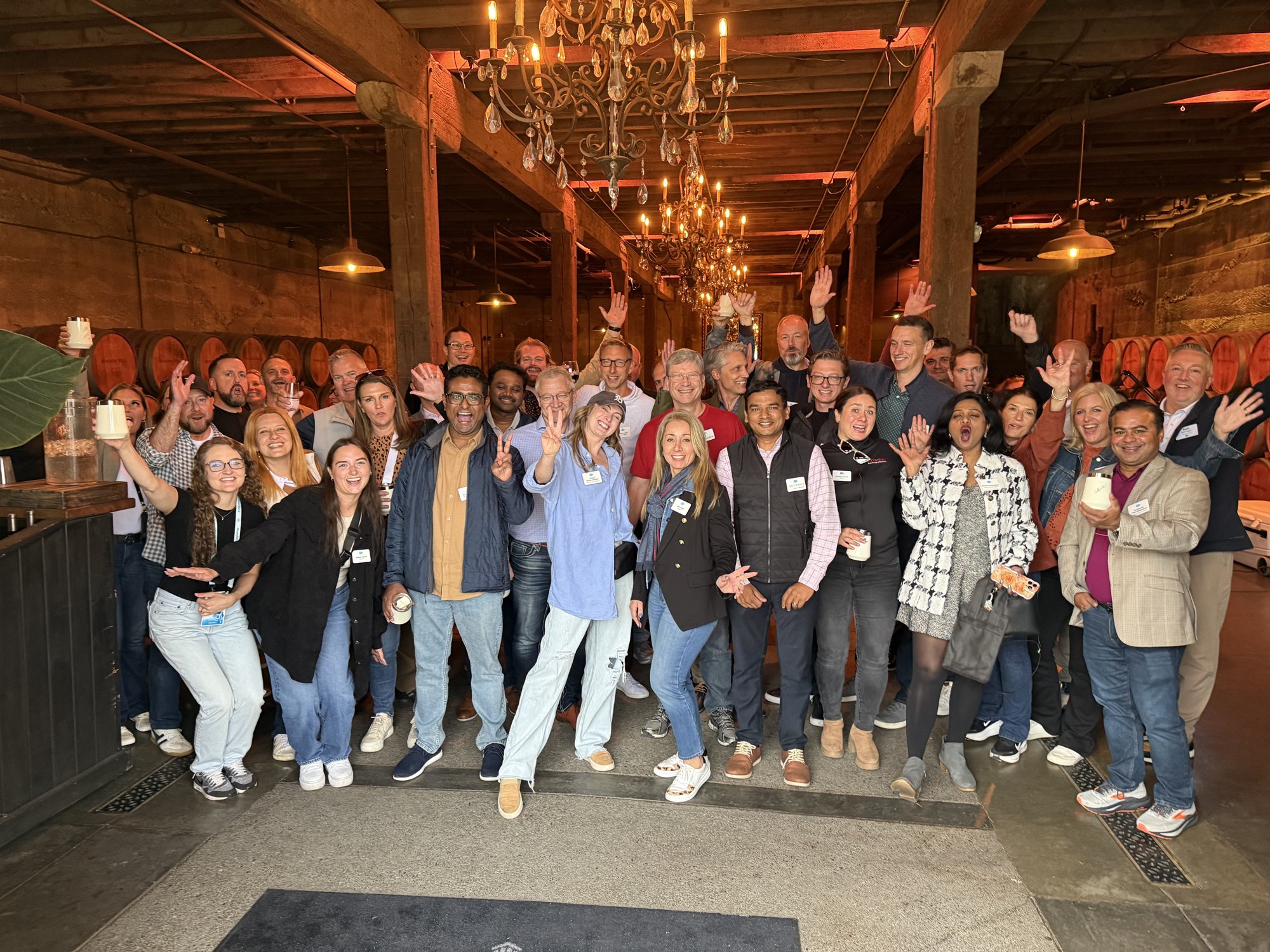 A corporate group celebrating together in a Livermore Valley barrel room